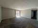 Spacious living room with grey carpet and sliding door access to a patio at 5181 River Glen Dr # 172, Las Vegas, NV 89103