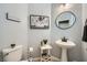 Charming bathroom with pedestal sink, round mirror, and decorative accents at 5442 Bristol Bend Ct, Las Vegas, NV 89135