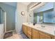 Double vanity bathroom with light wood cabinets and a large mirror at 5442 Bristol Bend Ct, Las Vegas, NV 89135