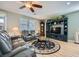 Spacious living room with gray leather sofas, ceiling fan, and built-in entertainment center at 5442 Bristol Bend Ct, Las Vegas, NV 89135