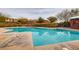 Community pool with surrounding lounge chairs and landscaping at 5442 Bristol Bend Ct, Las Vegas, NV 89135