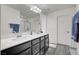 Double vanity bathroom with dark cabinets and large mirror at 6201 Ashley Hills Ave, Las Vegas, NV 89141