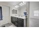 Double vanity bathroom with dark cabinets and a shower at 6201 Ashley Hills Ave, Las Vegas, NV 89141