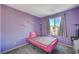 Charming bedroom with pink bedding and a window at 6201 Ashley Hills Ave, Las Vegas, NV 89141