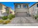 Two-story house with gray exterior, landscaped yard, and attached garage at 6201 Ashley Hills Ave, Las Vegas, NV 89141