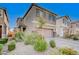 Two-story house with gray exterior, landscaped yard, and two-car garage at 6201 Ashley Hills Ave, Las Vegas, NV 89141