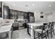 Modern kitchen with dark cabinetry, quartz countertops, and stainless steel appliances at 6201 Ashley Hills Ave, Las Vegas, NV 89141