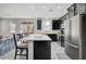 Modern kitchen with island, dark cabinets, and stainless steel appliances at 6201 Ashley Hills Ave, Las Vegas, NV 89141