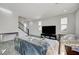 Living room with gray tile floors and staircase to upper level at 6201 Ashley Hills Ave, Las Vegas, NV 89141