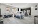 Open living room with dark kitchen cabinets and gray tile floors at 6201 Ashley Hills Ave, Las Vegas, NV 89141