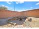 Fire pit area in a backyard with brick walls at 6227 Legend Falls St, North Las Vegas, NV 89081