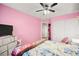 Pink bedroom with ceiling fan, dresser and a full-size bed at 6227 Legend Falls St, North Las Vegas, NV 89081