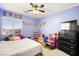 Blue bedroom with ceiling fan, dresser and a full-size bed at 6227 Legend Falls St, North Las Vegas, NV 89081