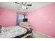 Pink bedroom with ceiling fan, dresser and a full-size bed at 6227 Legend Falls St, North Las Vegas, NV 89081