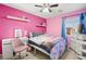 Pink bedroom with ceiling fan, dresser and a full-size bed at 6227 Legend Falls St, North Las Vegas, NV 89081