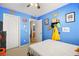 Bright blue-walled bedroom with double doors and a bed at 6227 Legend Falls St, North Las Vegas, NV 89081