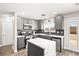 Modern kitchen with gray cabinets, white quartz countertops and island at 6227 Legend Falls St, North Las Vegas, NV 89081