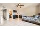 Spacious bedroom with a queen-size bed, en-suite bathroom, and tile floor at 6381 W Washington Ave, Las Vegas, NV 89107