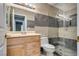 Modern bathroom with gray tile and glass shower at 6725 Carrera Dr, Las Vegas, NV 89103