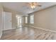 Bright bedroom with mirrored closet doors and wood-look floors at 6725 Carrera Dr, Las Vegas, NV 89103