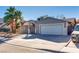 House exterior showcasing a two-car garage and palm trees at 6725 Carrera Dr, Las Vegas, NV 89103