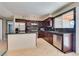 Modern kitchen with dark wood cabinets and granite countertops at 6725 Carrera Dr, Las Vegas, NV 89103