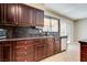 Kitchen with dark wood cabinets and granite countertops at 6725 Carrera Dr, Las Vegas, NV 89103