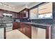 Updated kitchen, featuring dark wood cabinets and stainless steel appliances at 6725 Carrera Dr, Las Vegas, NV 89103