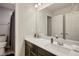 Clean bathroom with dark vanity, quartz countertop, and a large mirror at 707 Cottonwood Hill Pl, Henderson, NV 89011