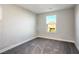 Bright bedroom with grey carpet and large window, offering ample natural light at 707 Cottonwood Hill Pl, Henderson, NV 89011