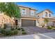 Two-story house with a two-car garage and landscaped front yard at 707 Cottonwood Hill Pl, Henderson, NV 89011