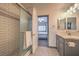 Bathroom with shower, vanity, and view of bedroom at 7163 Brassica Ct, Las Vegas, NV 89148