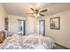 Cozy bedroom featuring a ceiling fan and adjacent bathroom at 7163 Brassica Ct, Las Vegas, NV 89148