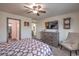 Bedroom with large TV, dresser, and adjacent bathroom at 7163 Brassica Ct, Las Vegas, NV 89148