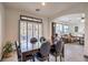 Dining area with wooden table and chairs, view into living room and backyard at 7163 Brassica Ct, Las Vegas, NV 89148