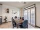 Bright dining area with dark wood table and six chairs, adjacent to kitchen at 7163 Brassica Ct, Las Vegas, NV 89148