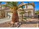 Two-story house with attached garage and palm trees at 7163 Brassica Ct, Las Vegas, NV 89148