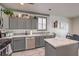 Modern kitchen with gray cabinets, stainless steel appliances and white countertops at 7163 Brassica Ct, Las Vegas, NV 89148