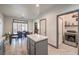 Open concept kitchen and dining area with island and laundry access at 7163 Brassica Ct, Las Vegas, NV 89148