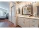 Bright bathroom with white vanity, bathtub, and shower at 7925 Settlers Ridge Ln, Las Vegas, NV 89145