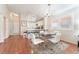 Open dining area with hardwood floors and view into the kitchen and living room at 7925 Settlers Ridge Ln, Las Vegas, NV 89145