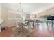 Bright dining room with glass table, four chairs, and hardwood floors at 7925 Settlers Ridge Ln, Las Vegas, NV 89145