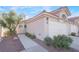 Well-maintained home with walkway, two-car garage, and drought-tolerant landscaping at 7925 Settlers Ridge Ln, Las Vegas, NV 89145