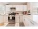 Spacious kitchen with white cabinets, stainless steel appliances, and quartz countertops at 7925 Settlers Ridge Ln, Las Vegas, NV 89145