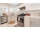 Updated kitchen featuring white cabinets, stainless steel appliances, and corner sink at 7925 Settlers Ridge Ln, Las Vegas, NV 89145