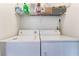 Laundry room with washer, dryer, and overhead shelving for storage at 7925 Settlers Ridge Ln, Las Vegas, NV 89145