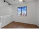 Upstairs bedroom with wood floors and window view at 8101 Spur Ct, Las Vegas, NV 89145