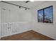 Upstairs bedroom with wood floors and window view at 8101 Spur Ct, Las Vegas, NV 89145