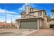 Two-story house with a gray garage door and a spacious driveway at 8101 Spur Ct, Las Vegas, NV 89145