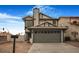 Two-story house with beige siding, green garage door, and mailbox at 8101 Spur Ct, Las Vegas, NV 89145